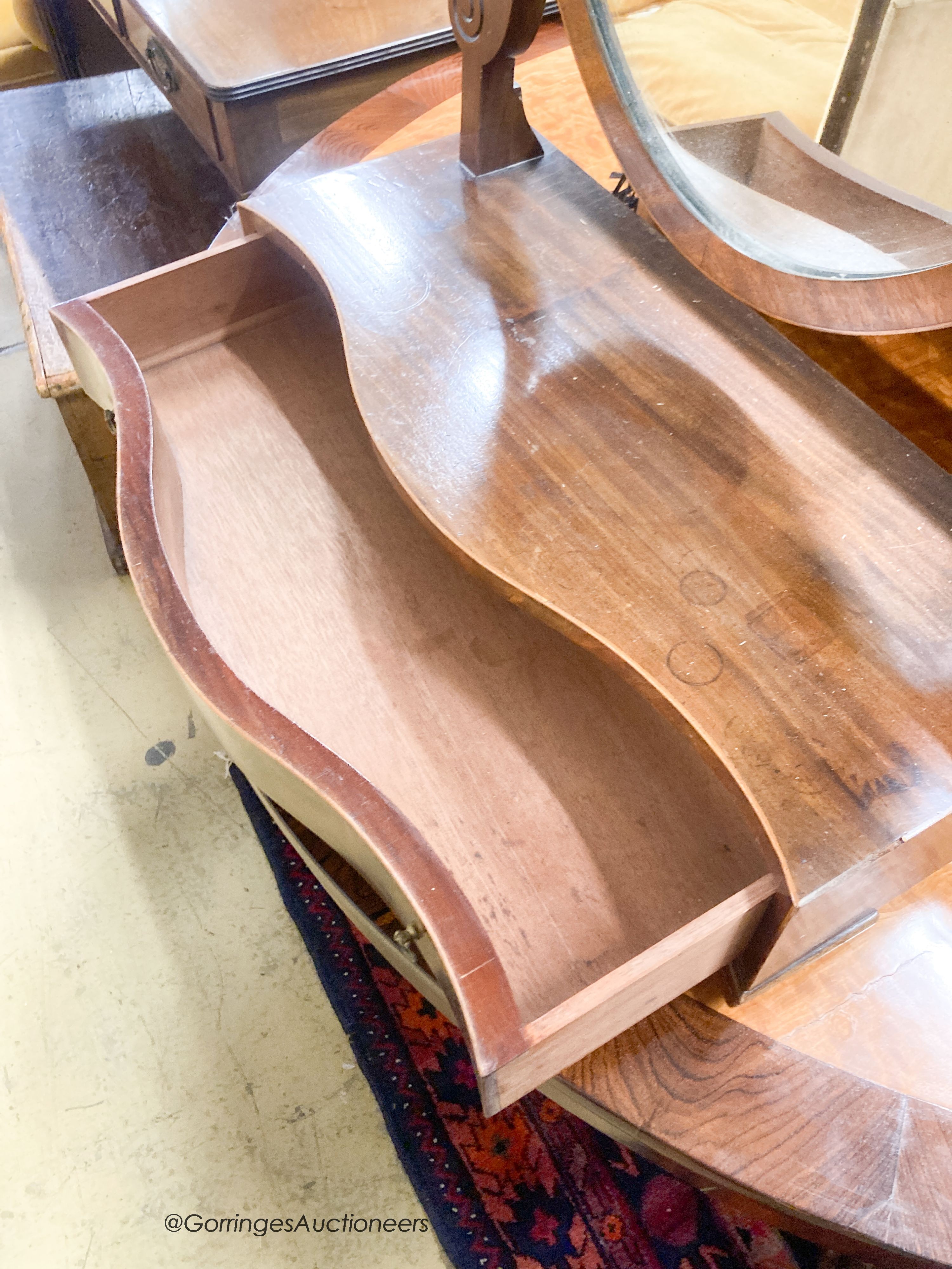 An Edwardian George III style mahogany serpentine toilet mirror, width 61cm, height 90cm